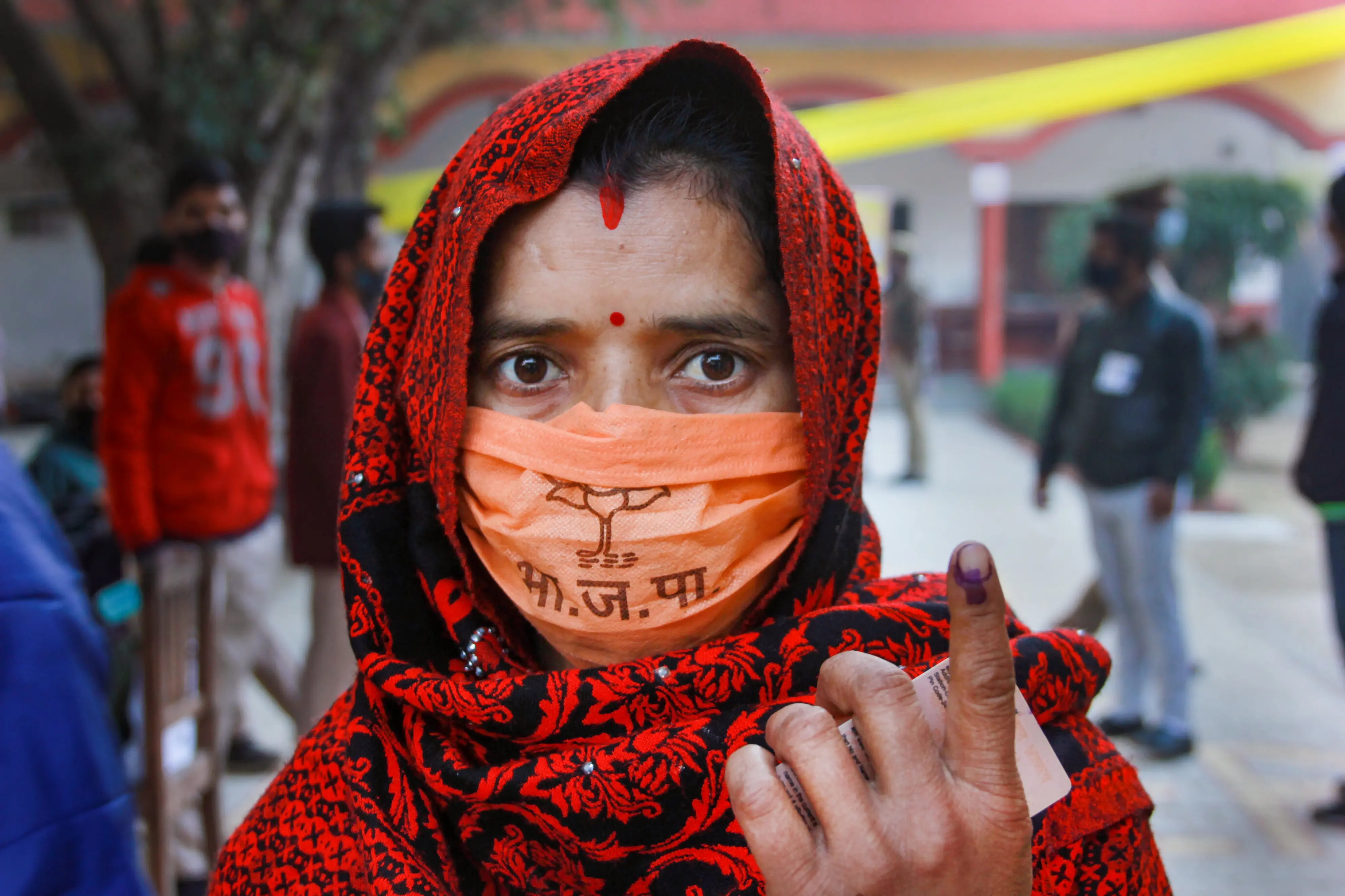 A woman shows her finger marked with indelible ink after casting their vote at a polling booth, during the second phase of Uttar Pradesh Assembly elections | Photo: PTI