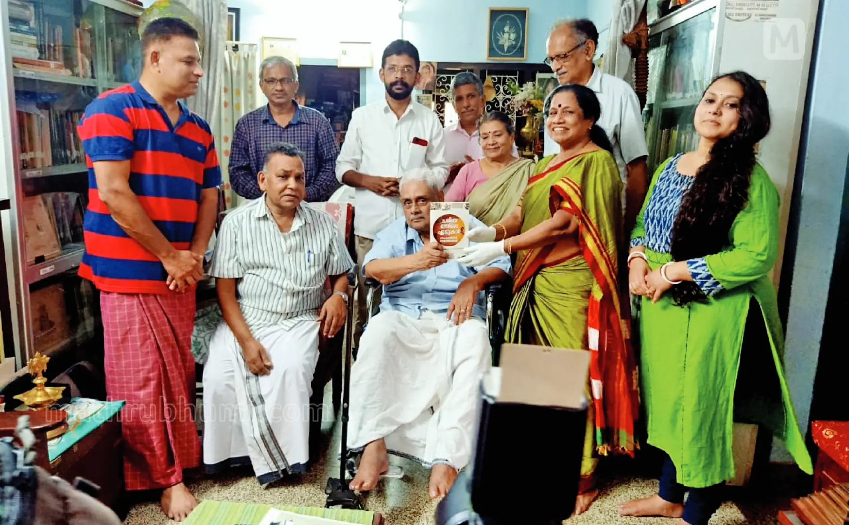 MGS Narayanan giving his book 'Charithrathile Edukal' to his disciple Dr E K Swarnakumari as Vishukaineettam. Prof K Gopalankutty, Dr Arzu, RS Panicker, P I Ajayan, Sudhakaran T K, Sunny Joseph, MGS Narayanan's wife Permalatha, son Vijayakumar and daughter Vinaya also are seen.