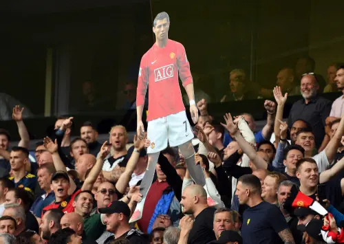 A cardboard cut out of Cristiano Ronaldo held by Manchester United supporters I Photo: AFPa