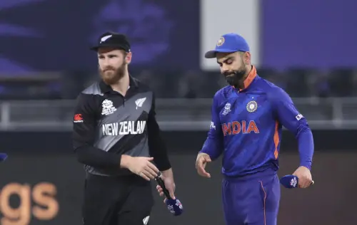 New Zealand's captain Kane Williamson, left, leaves after wining the toss as India's captain Virat Kohli watches at the start of their game during the Cricket Twenty20 World Cup match in Dubai, UAE, Sunday, Oct. 31, 2021. (AP Photo)