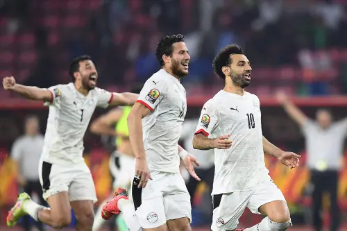 Mohamed Salah (C) celebrates with teammates | AFP