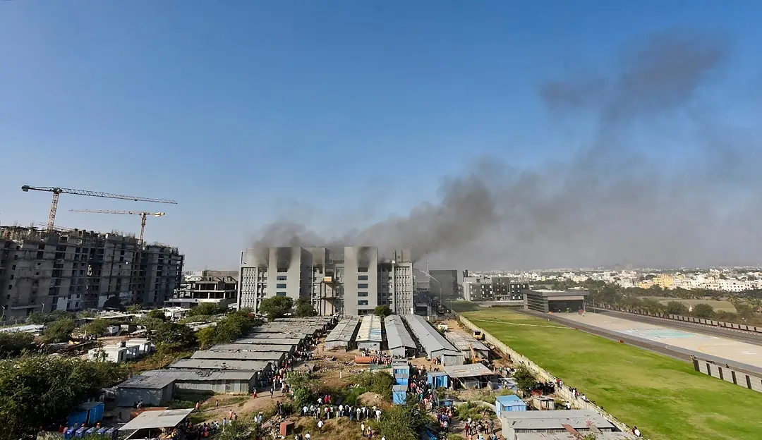 Workers of Serum Institute of India come out of the building after fire broke out in it, in Pune on Thursday | Photo: PTI