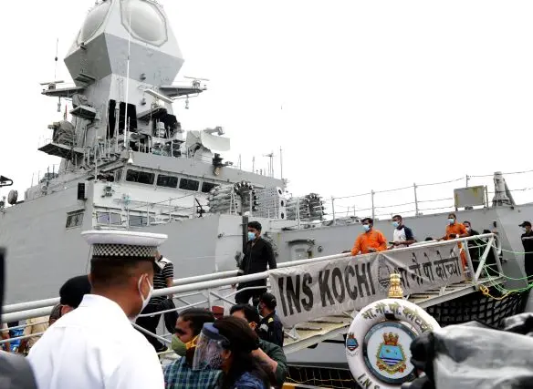 Crew rescued by Indian Navy from Barge P305 off the coast of Mumbai, walks out of INS Kochi after arriving in Mumbai on Wednesday. | Photo:PTI