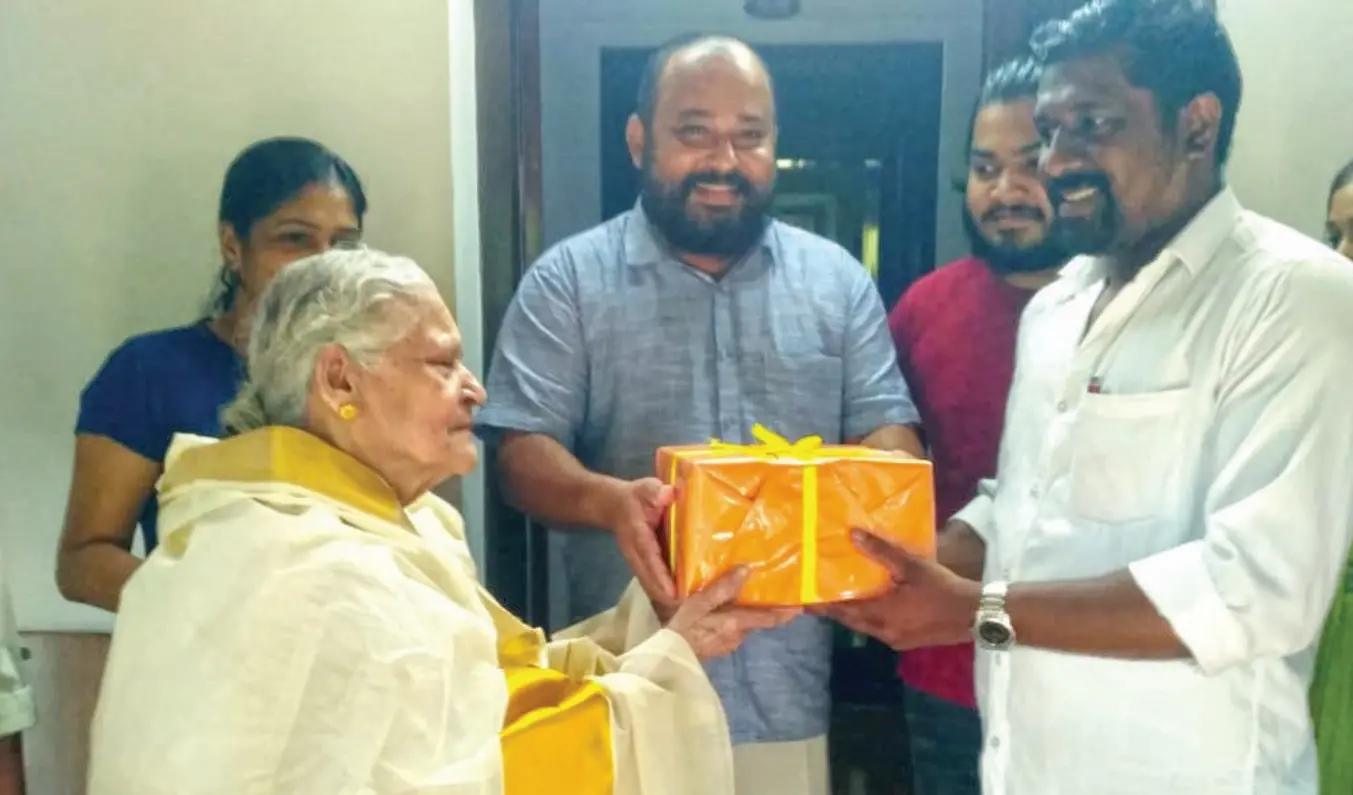 Padmini teacher handing over books to the library authorities
