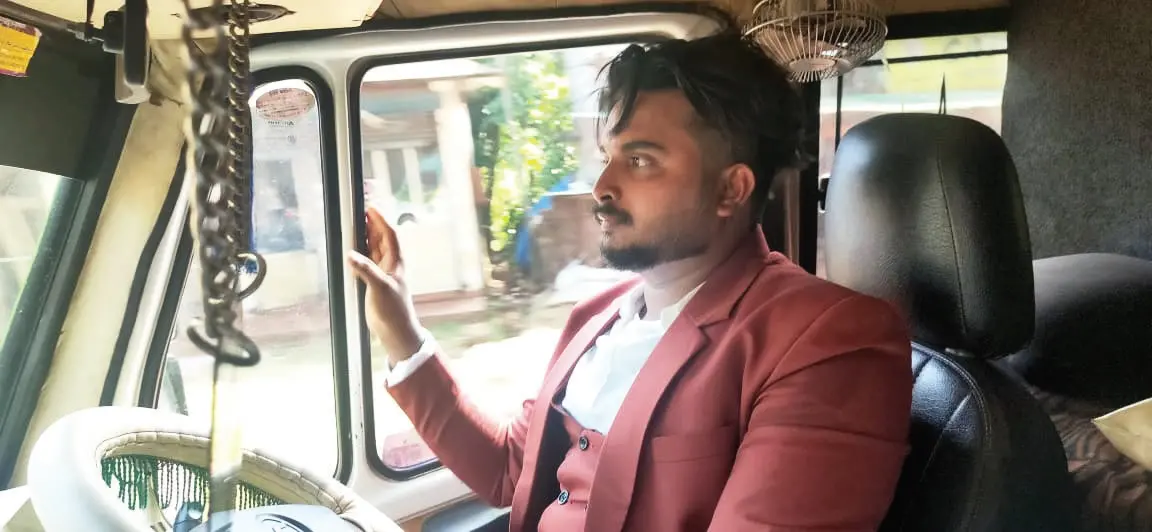 Musaddiq driving ambulance wearing wedding attire