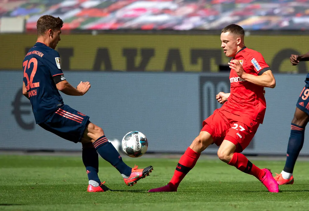Florian Wirtz of Bayer Leverkusen, right, is challenged by FC Bayern Munich's Joshua Kimmich during a German Bundesliga match. (Photo: AP)