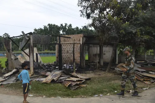 A paramilitary soldier patrols past a shop that was set on fire in Rowa village, about 220 kilometers from Agartala, Tripura, Wednesday, Oct. 27 2021 | Photo: AP Photo
