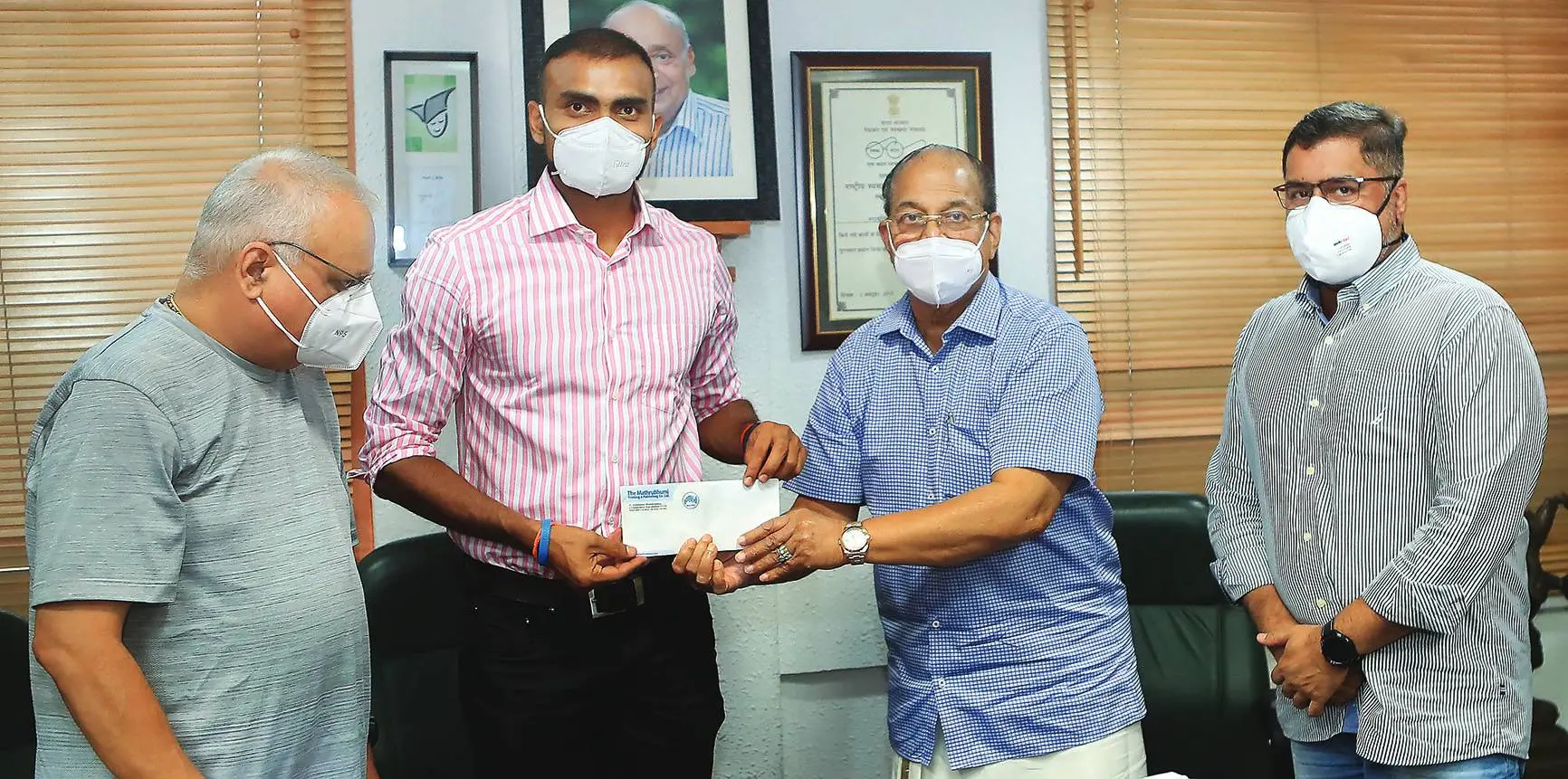 P R Sreejesh being gifted the cash award by the Chairman and Managing Editor of Mathrubhumi, P V Chandran. Managing Director of Mathrubhumi, MP M V Shreyams Kumar and Mathrubhumi Joint Managing Editor P V Nidheesh are seen in the picture | Photo: Mathrubhumi