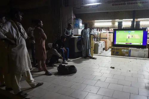 Cricket fans watch the live telecast of T20 cricket World Cup match between Pakistan and India I AFP