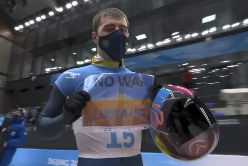 Beijing winter olympics: Ukrainian athlete displays sign calling for 'No War in Ukraine'