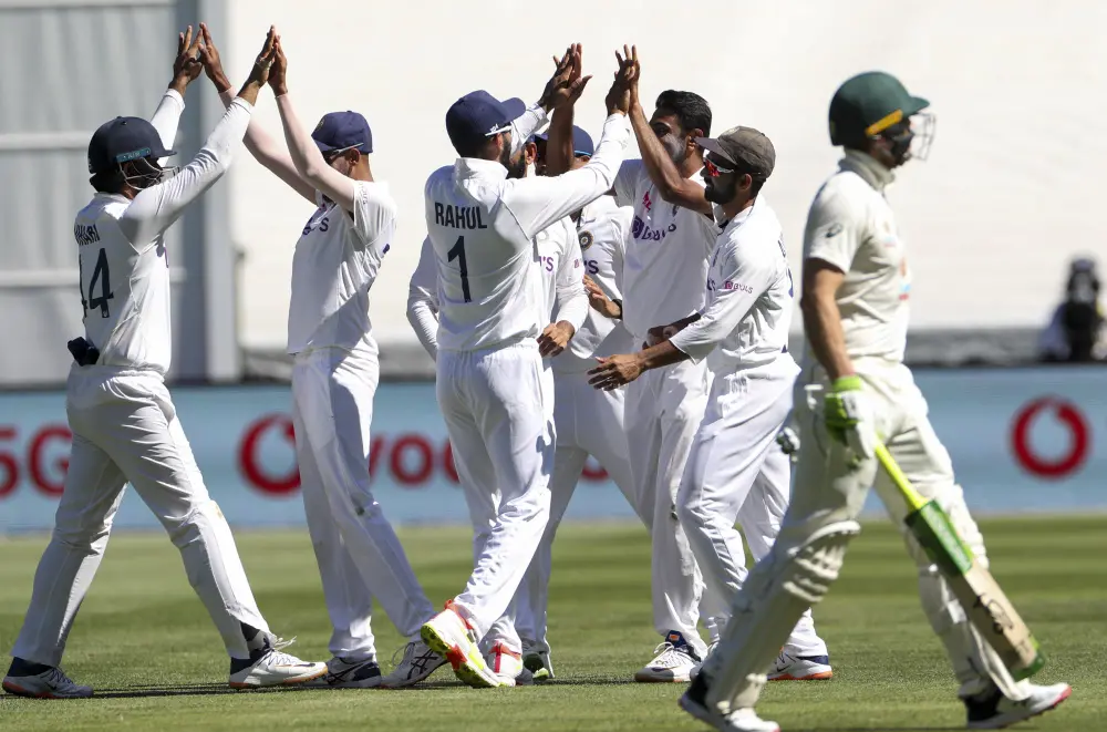 Indian players celebrate the dismissal of Australia's Tim Paine, during play on day one of the Boxing Day cricket test between India and Australia at the Melbourne Cricket Ground | AP
