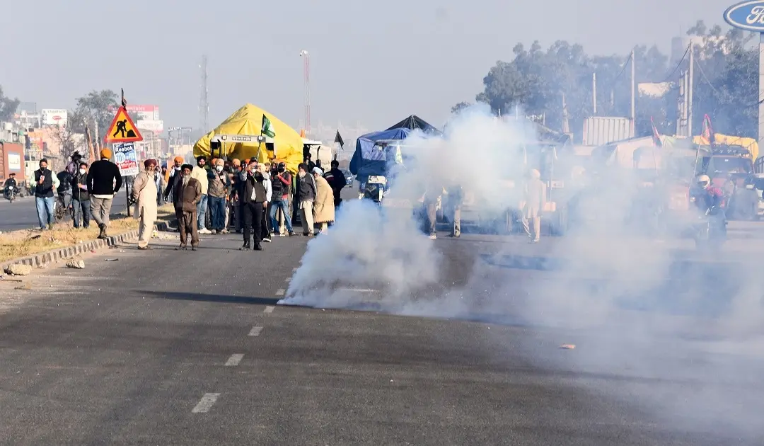 Teargas shells fired by Delhi Police land near protesting farmers to warn them, as they try to cross the border into Delhi during their 'Delhi Chalo' protest against Kisan Bill, at Singhu border in New Delhi | Phot: PTI
