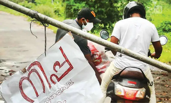 Health workers delivering essentials for people after the area was blocked as part of precaution