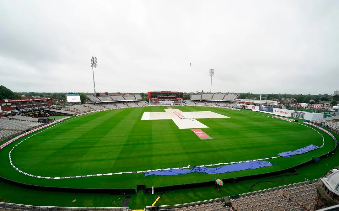 The pitch area is seen covered after rain delayed start of the third day of the second cricket Test match between England and West Indies at Old Trafford in Manchester, England, Saturday. (PTI photo)