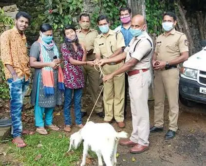 Police officers handing over a baby goat to Gayathri | Photo: Mathrubhumi