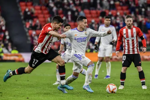 Lucas Vazquez, center, fights for the ball with Athletic Bilbao's Yuri Berchiche | AP