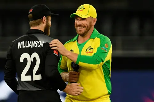 Australia's captain Aaron Finch (R) speaks with his New Zealand's counterpart Kane Williamson after the toss before the start of the ICC men's Twenty20 World Cup final match between Australia and New Zealand at the Dubai International Cricket Stadium in Dubai on November 14, 2021. | Photo: AFP