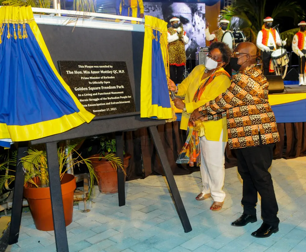 Barbados Prime Minister Mia Amor Mottley (2R) and Member of Parliament Trevor Prescott (R) unveil the plaque at the official opening of Golden Square Freedom Park in Bridgetown, Barbados | AFP