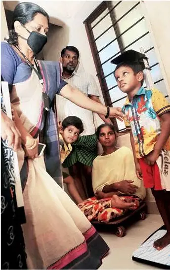 Child Development Project Officer checking weight of Saradas' children at her house (Photo: V S Shine)