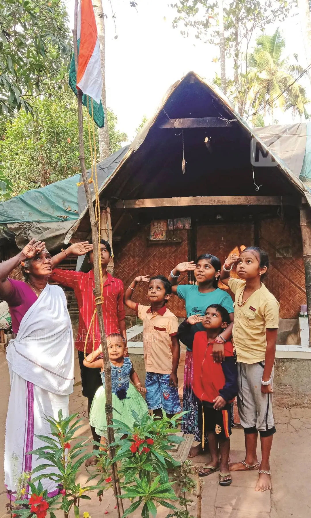 Ammini raises national flag with grandchildren