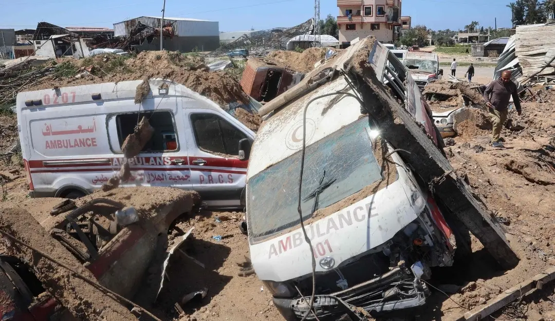 Palestinians inspect the damage at an ambulance repair yard hit in Israeli strikes. | Photo: AFP