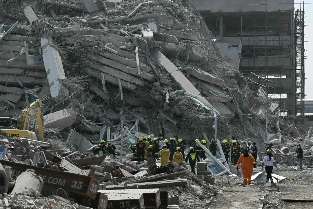 Rescue teams are seen at a construction site where a building collapsed in Bangkok after an earthquake | Photo: AFP