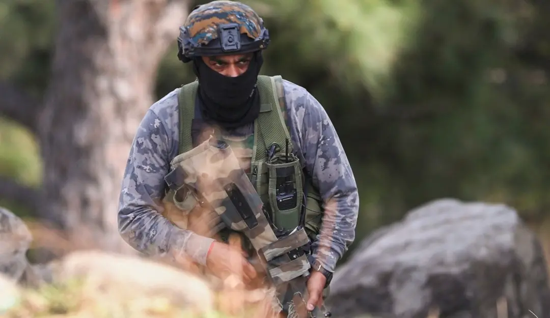 A security personnel takes position during an encounter which broke out between terrorists and security forces in Kathua district. | Photo: PTI