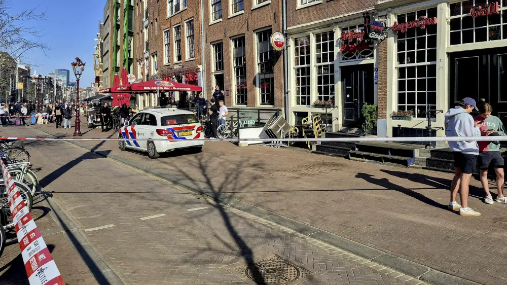Police cordon the area where five person were wounded during a stabbing attack near the central Dam Square in Amsterdam | AFP