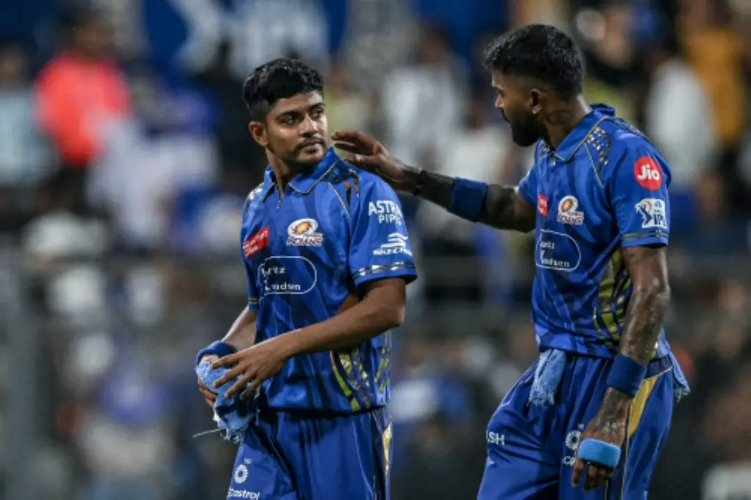 Mumbai Indians' captain Hardik Pandya (R) speaks with his teammate Ashwani Kumar during the Indian Premier League (IPL) Twenty20 cricket match between Mumbai Indians and Kolkata Knight Riders at the Wankhede Stadium in Mumbai. | Photo: AFP