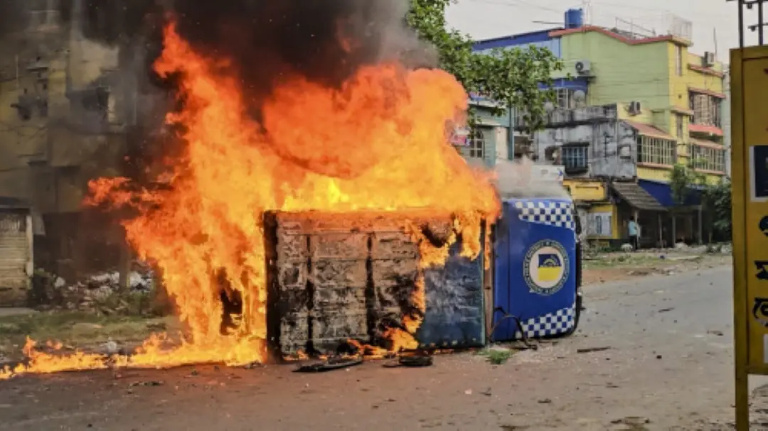 Smoke and flames billow out from a vehicle after it was set ablaze during a protest over the Waqf (Amendment) Act, in Murshidabad district of West Bengal. | Photo: PTI