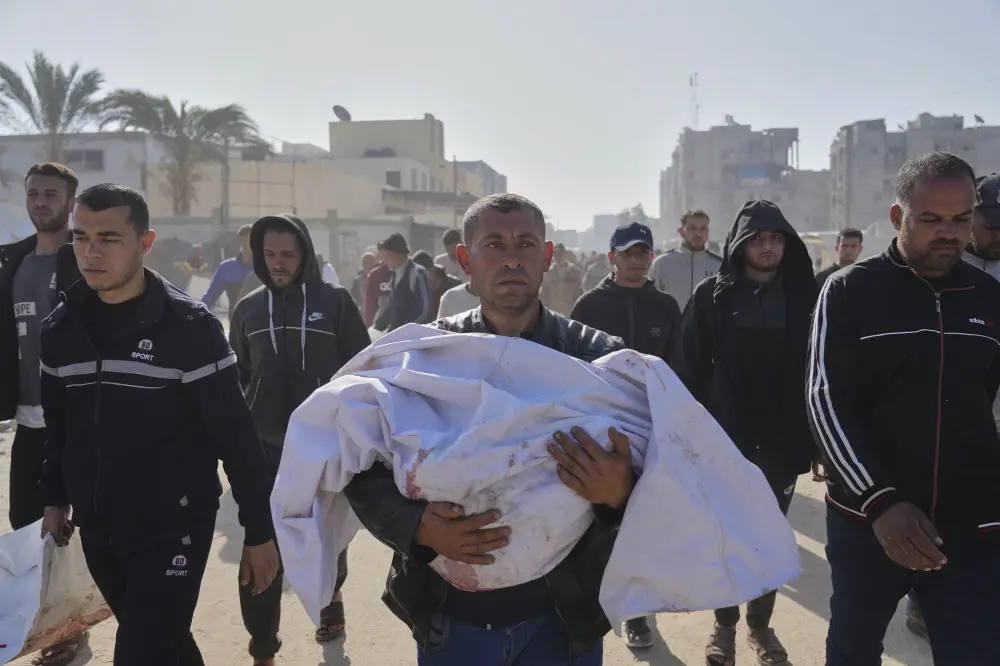 Man carrying body of his nephew who was killed in an Israeli army airstrike | AP