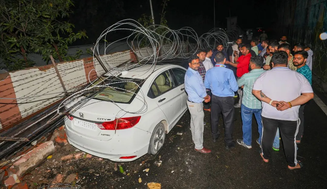 A portion of the boundary wall of the Civil Secretariat collapsed due to wind storm damaging vehicles, in Jammu (Photo: PTI)