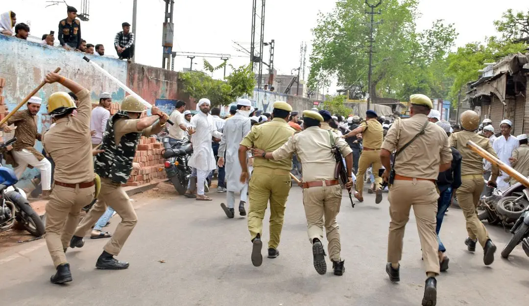 Police personnel baton charge on people protesting after some animal flesh was allegedly found inside Shahi Jama Masjid in Agra on Friday, April 12, 2025.