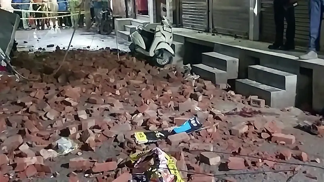 Debris are seen lying at the site where a wall of an under-construction building collapsed in Madhu Vihar Police Station during dust storm | ANI