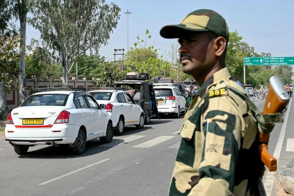 An Indian Border Security Force (BSF) personnel stands guard as Pakistani citizens return to their country through the India-Pakistan Attari-Wagah border post | AFP