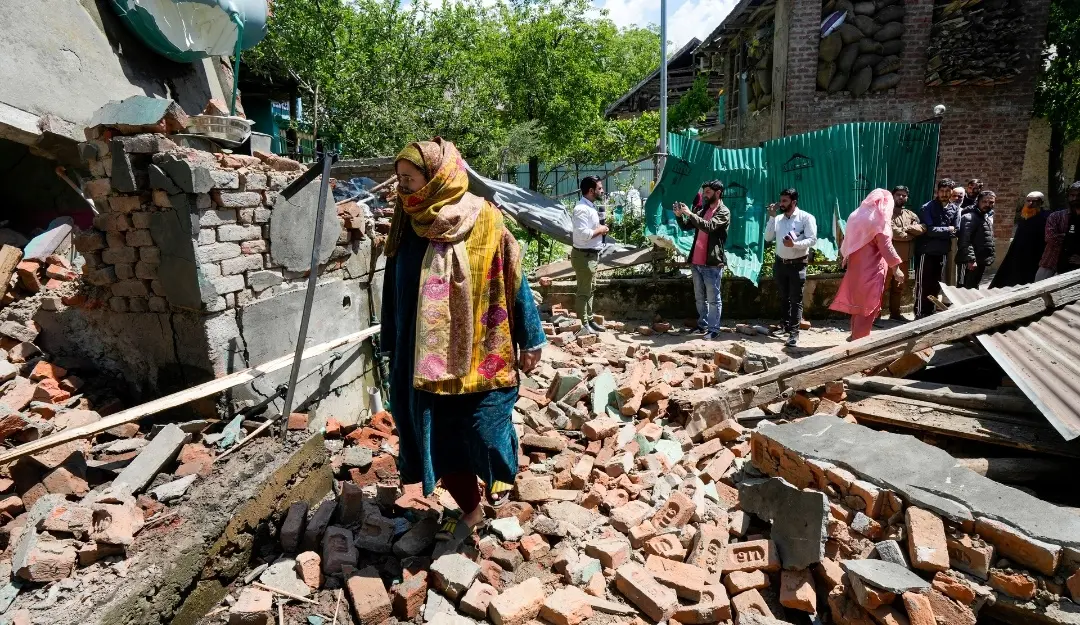A woman walks through the debris of Lashkar-e-Taiba terrorist Asif Sheikh's house in Tral, Pulwama, after authorities razed it following his alleged role in the Pahalgam terror attack. | Photo: PTI