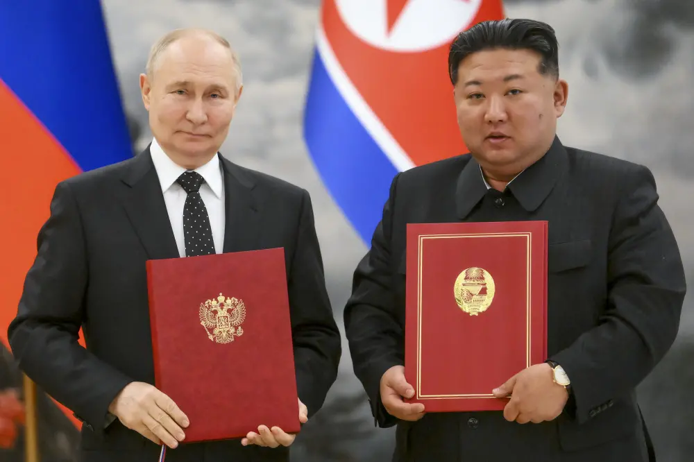 Vladimir Putin, left, and North Korea's leader Kim Jong Un | AP