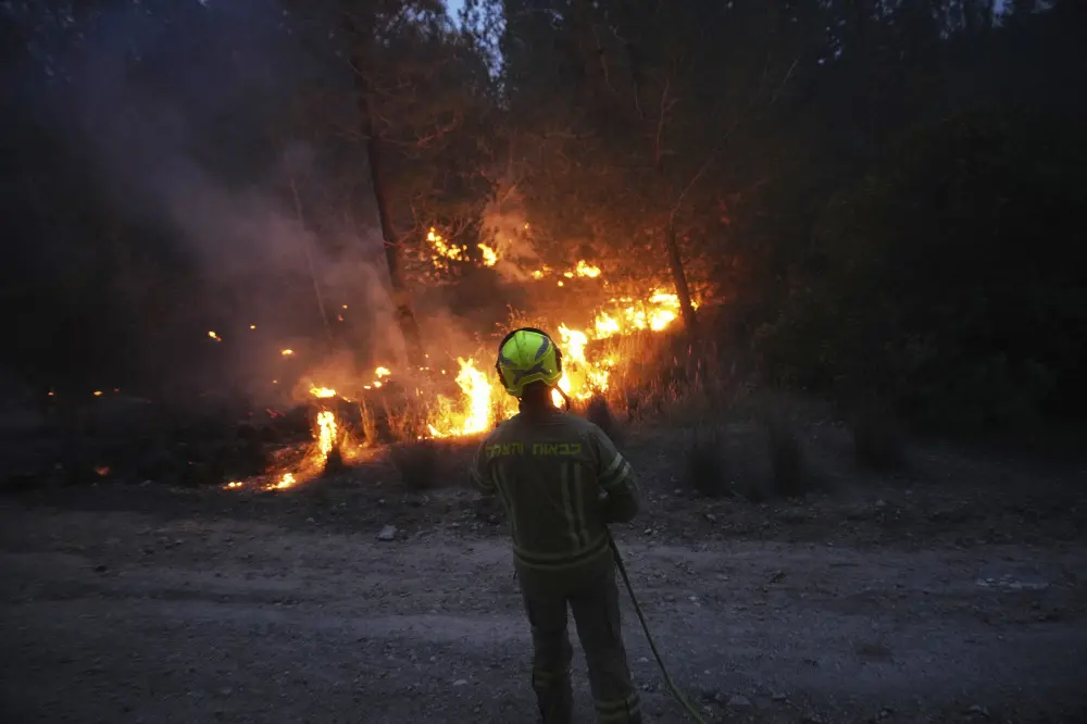 An Israeli firefighter works as forest fire is burning near Jerusalem| AP Photo