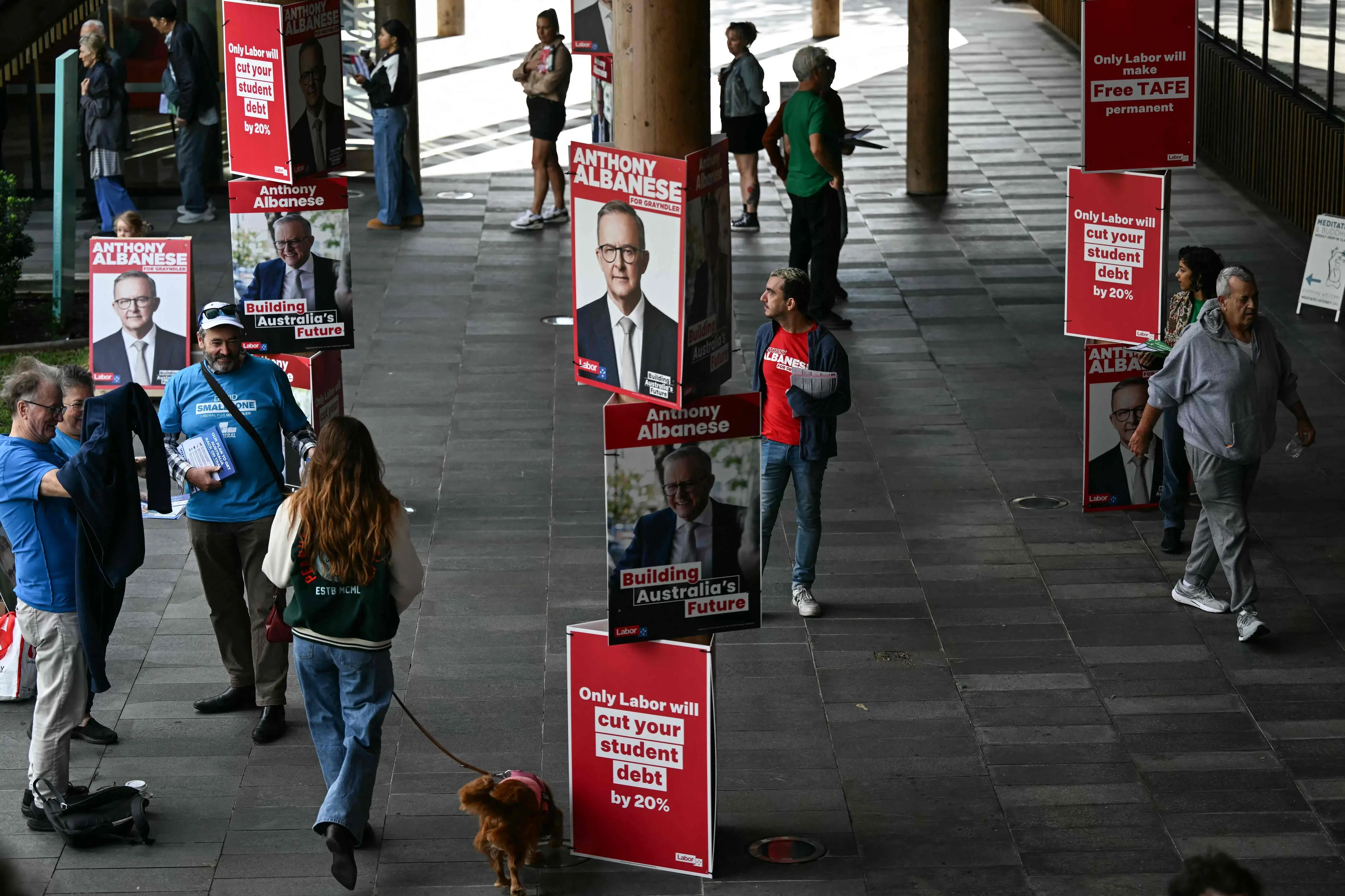Posters of Australia's Prime Minister Anthony Albanese for the general election are displayed outside a polling centre in the suburb of Marrickville in Sydney | Photo: AFP