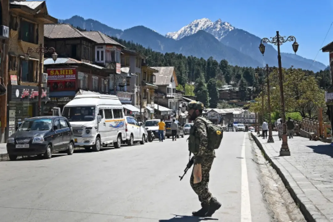 Indian paramilitary trooper patrols at a market area in Pahalgam south of Srinagar. | Photo: AFP