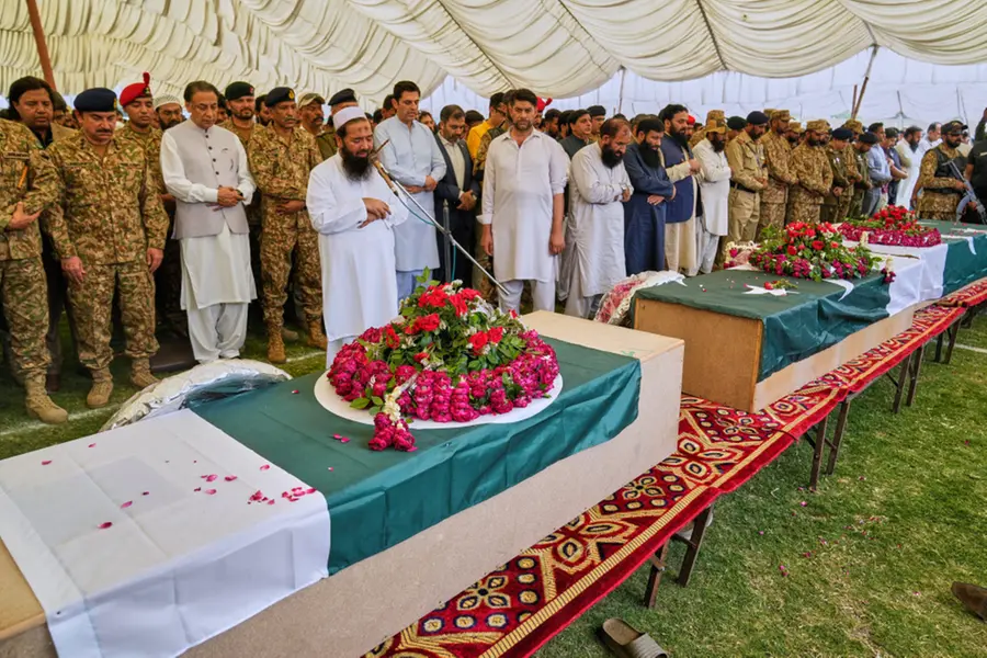 Pakistan army soldiers and others offer funeral prayers to the victims of a suspected Indian missile strike incident