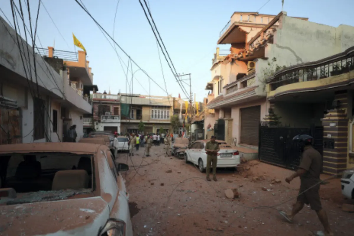 Security personnel and civilians gather near houses and vehicles damaged due to an attack from Pakistan, in Jammu, Saturday, May 10, 2025. | Photo: PTI