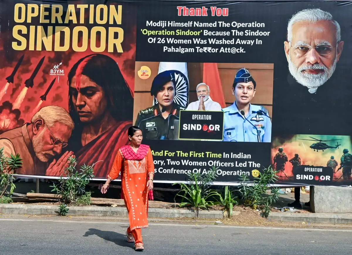 A woman walks past a poster of 'Operation Sindoor' | ANI