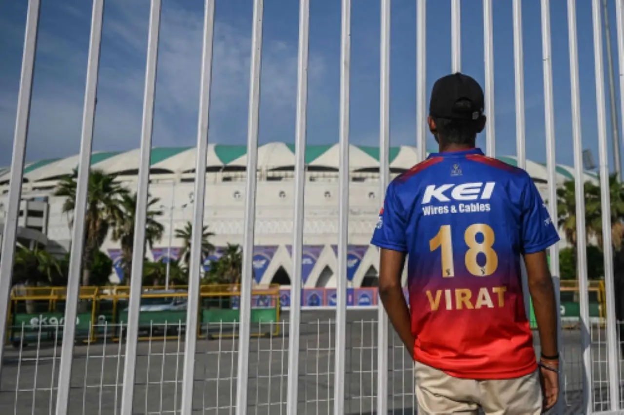 A cricket fan stands outside the Ekana Cricket Stadium in Lucknow, after the Indian Premier League (IPL) Twenty20 cricket tournament was suspended for a week following the cross-border tensions between India and Pakistan. | Photo: AFP