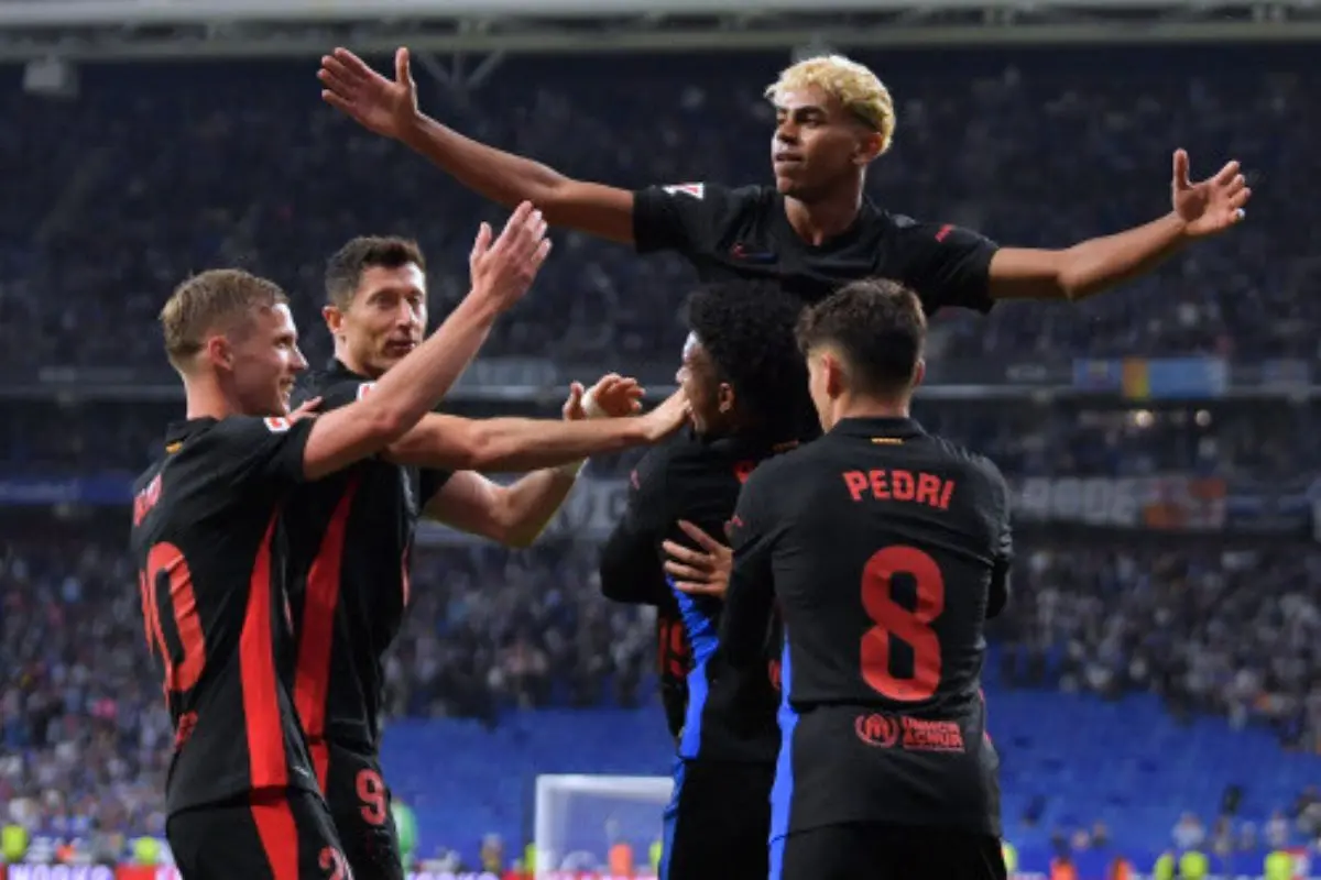 Barcelona's Spanish forward #19 Lamine Yamal (C) celebrates scoring his team's first goal during the Spanish league football match between RCD Espanyol and FC Barcelona at the RCDE Stadium in Cornella de Llobregat, on May 15, 2025. | Photo:  AFP