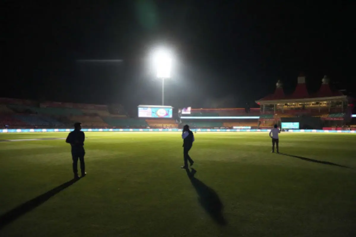 Officials walk on the playing field after the authorities asked to evacuate the stadium during the Indian Premier League cricket match between Punjab Kings and Delhi Capitals at Himachal Pradesh Cricket Association Stadium in Dharamshala, India, Thursday, May 8, 2025. | Photo: AP