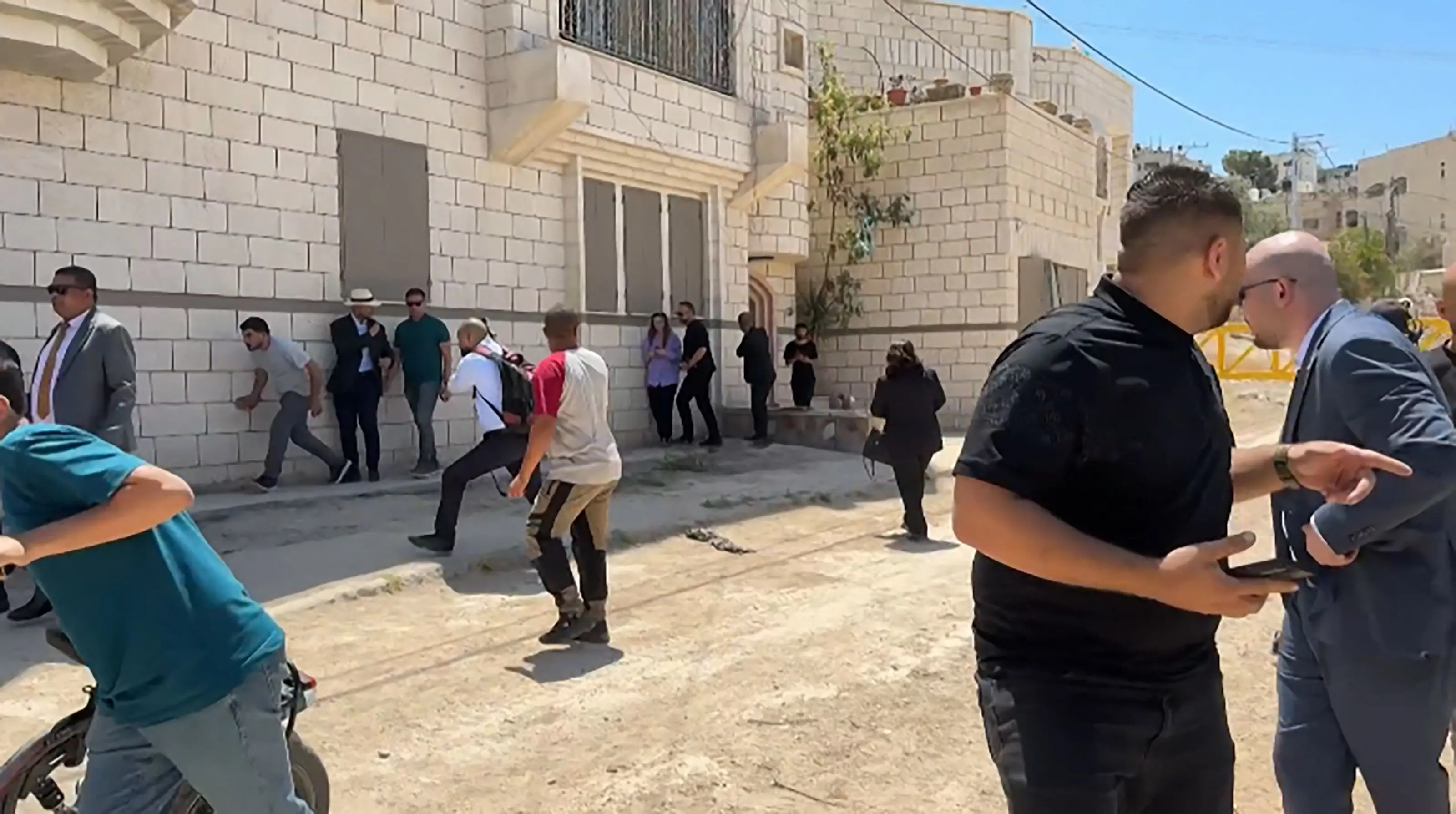 Members of a diplomatic delegation from the European Union reacting after shots were fired amid an ongoing Israeli military offensive in the occupied West Bank. | Photo: AFP