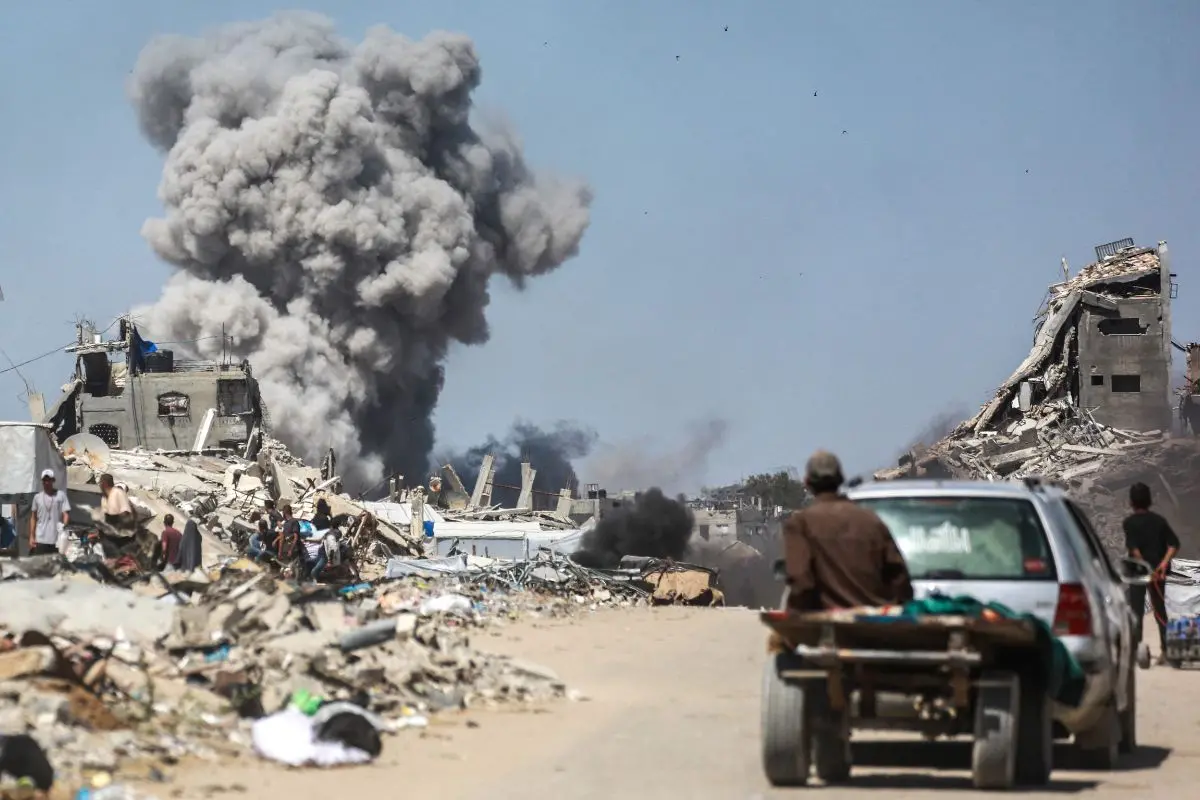 People watch as smoke billows following an Israeli strike in Jabalia, in the northern Gaza Strip on May 25, 2025 (Photo: AFP)