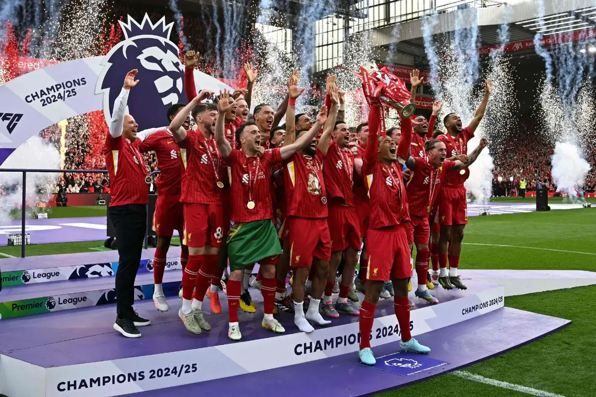 Liverpool players celebrate with the EPL trophy as captain and Dutch defender Virgil van Dijk lifts the Premier League trophy at the end of the English Premier League football match between Liverpool and Crystal Palace at Anfield in Liverpool, north west England on May 25, 2025. Liverpool equalises 1 - 1 against Crystal Palace. | Photo : AFP