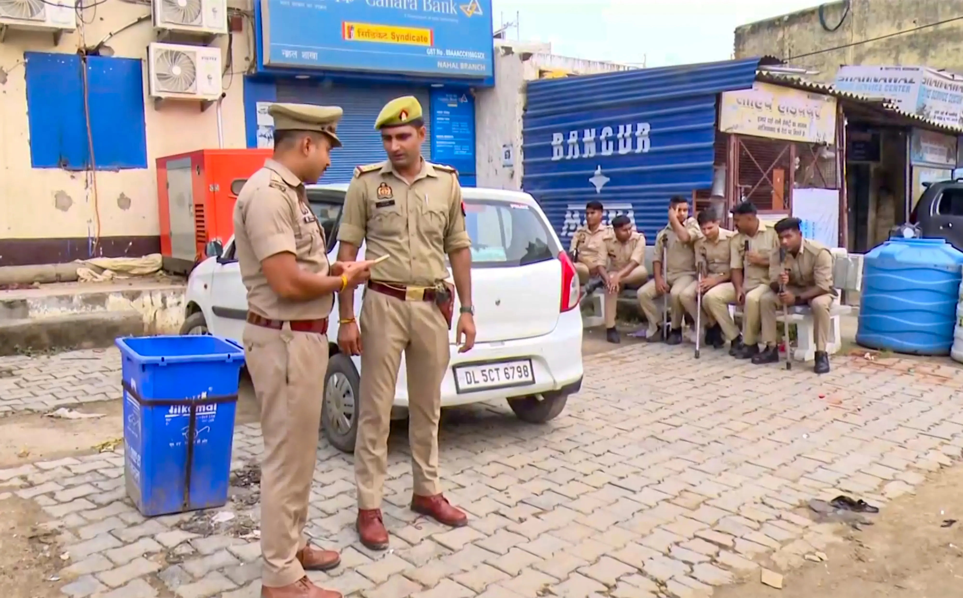 Police personnel stand guard after a constable who was shot dead by miscreants during a raid at Nahal village, in Ghaziabad district. | Photo: PTI